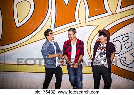 Stock Image - Friends talking at mural outdoors. Fotosearch