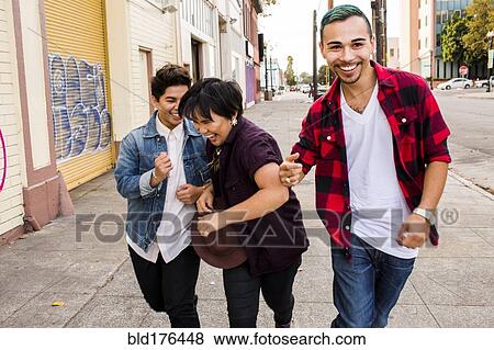 Stock Photo - Friends walking on sidewalk. Fotosearch