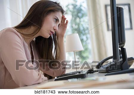 Frustrated Native American businesswoman working at computer View Large Photo Image Stock Image - Frustrated Native American businesswoman working at computer. Fotosearch