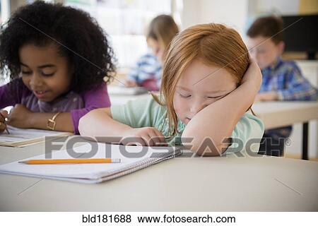 Frustrated student working in classroom View Large Photo Image Stock Photo - Frustrated student working in classroom. Fotosearch