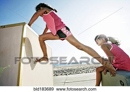 Girls climbing structure at beach View Large Photo Image Stock Photo - Girls climbing structure at beach. Fotosearch