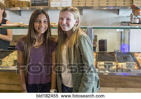 Stock Photography - Girls smiling in cafe. Fotosearch