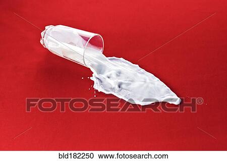 Stock Image - Glass with spilled milk. Fotosearch