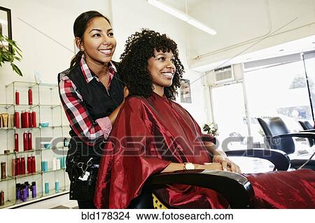 Hairstylist styling hair of customer in salon View Large Photo Image Picture - Hairstylist styling hair of customer in salon. Fotosearch