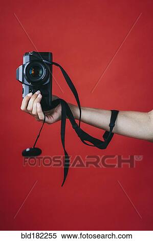 Stock Photography - Hand of woman holding camera. Fotosearch