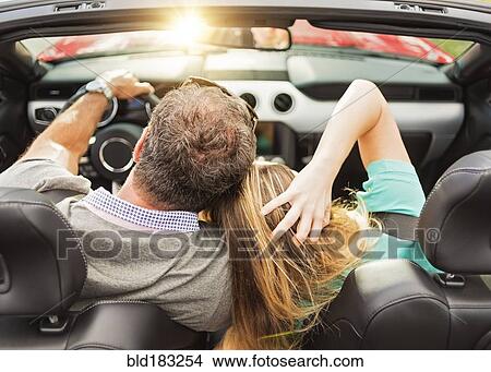 Picture - High angle view of Caucasian couple driving convertible. Fotosearch