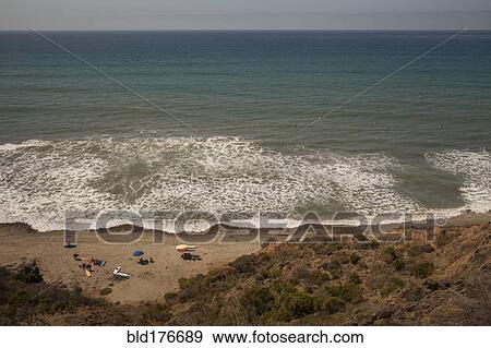 Stock Photo - High angle view of ocean waves on beach. Fotosearch