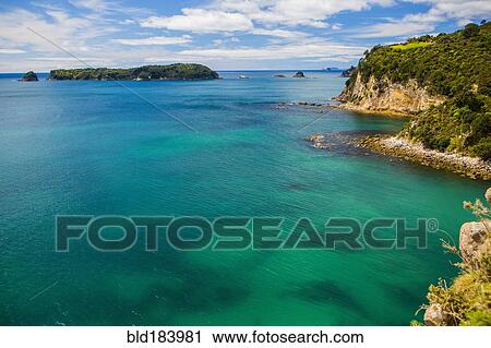 Stock Image - High angle view of remote cove and ocean horizon. Fotosearch