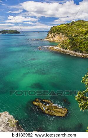 Stock Image - High angle view of remote cove and ocean horizon. Fotosearch