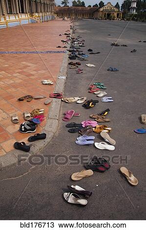 Stock Image - High angle view of sandals outside Buddhist temple. Fotosearch