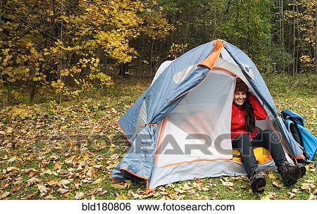 Hiker sitting in tent at campsite View Large Photo Image Stock Photograph - Hiker sitting in tent at campsite. Fotosearch