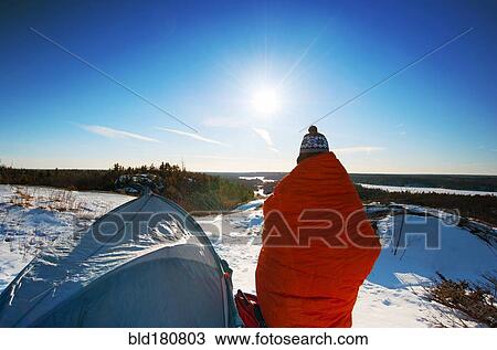 Hiker standing at snowy campsite View Large Photo Image Stock Image - Hiker standing at snowy campsite. Fotosearch