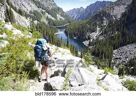 Hiker walking on rocky hillside View Large Photo Image Stock Photograph - Hiker walking on rocky hillside. Fotosearch