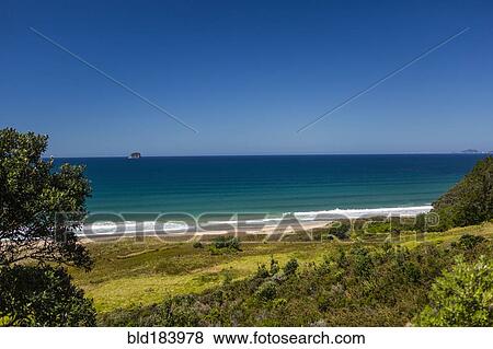 Hillside and remote beach under blue sky View Large Photo Image Stock Photo - Hillside and remote beach under blue sky. Fotosearch