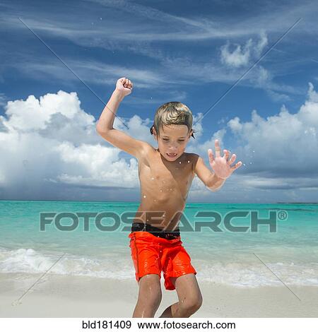 Hispanic boy playing on beach View Large Photo Image Stock Photo - Hispanic boy playing on beach. Fotosearch
