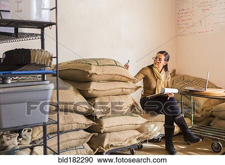 Hispanic business owner checking inventory View Large Photo Image Stock Image - Hispanic business owner checking inventory. Fotosearch