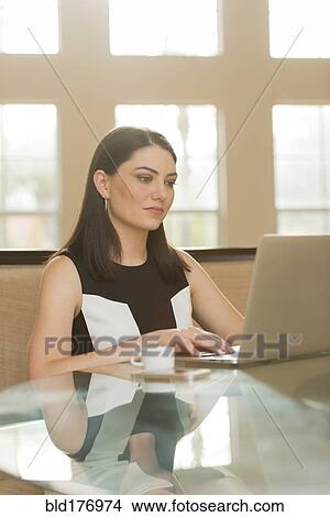 Hispanic businesswoman using laptop in office View Large Photo Image Picture - Hispanic businesswoman using laptop in office. Fotosearch