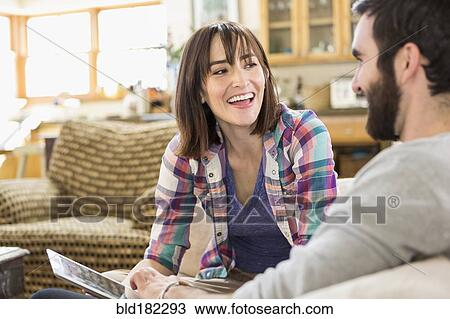Hispanic couple using digital tablet on sofa View Large Photo Image Stock Image - Hispanic couple using digital tablet on sofa. Fotosearch
