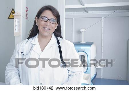 Stock Image - Hispanic doctor smiling in hospital. Fotosearch