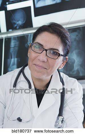 Stock Photo - Hispanic doctor smiling in hospital. Fotosearch
