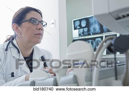 Hispanic doctor using machinery in hospital View Large Photo Image Stock Image - Hispanic doctor using machinery in hospital. Fotosearch