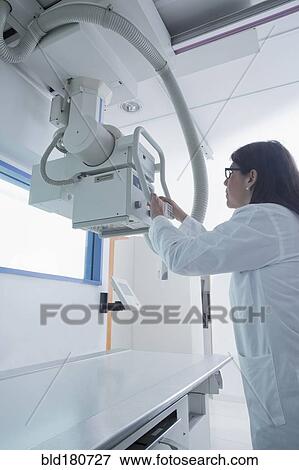 Stock Photo - Hispanic doctor using x-ray in hospital. Fotosearch