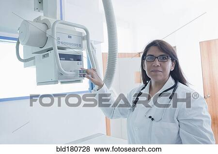 Stock Photo - Hispanic doctor using x-ray in hospital. Fotosearch