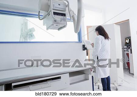 Stock Photo - Hispanic doctor using x-ray in hospital. Fotosearch