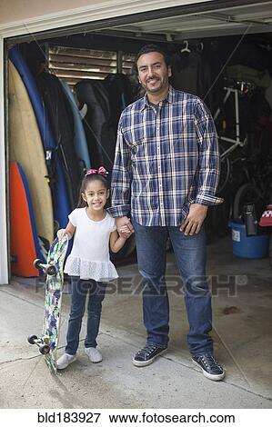 Hispanic father and daughter smiling in garage View Large Photo Image Stock Photo - Hispanic father and daughter smiling in garage. Fotosearch