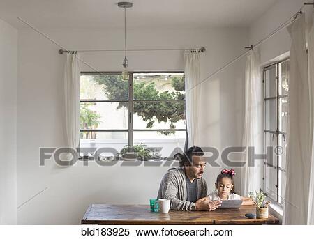 Hispanic father and daughter using digital tablet View Large Photo Image Stock Photography - Hispanic father and daughter using digital tablet. Fotosearch