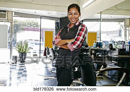 Hispanic hairstylist smiling in salon View Large Photo Image Stock Photograph - Hispanic hairstylist smiling in salon. Fotosearch
