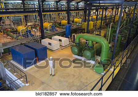 Stock Photo - Hispanic technician supervising power plant. Fotosearch