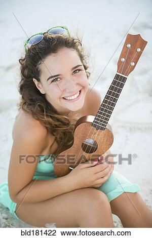 Hispanic teenage girl holding ukulele View Large Photo Image Stock Image - Hispanic teenage girl holding ukulele. Fotosearch