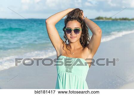 Hispanic teenage girl standing on beach View Large Photo Image Stock Photo - Hispanic teenage girl standing on beach. Fotosearch