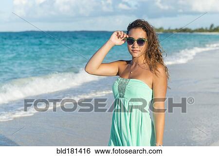 Hispanic teenage girl standing on beach View Large Photo Image Stock Photograph - Hispanic teenage girl standing on beach. Fotosearch
