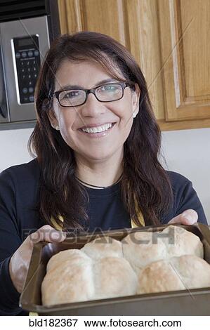 Stock Photo - Hispanic woman baking in kitchen. Fotosearch