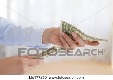 Stock Image - Hispanic woman counting money. Fotosearch