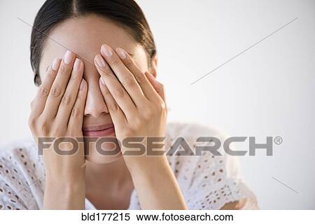 Hispanic woman covering her eyes View Large Photo Image Stock Photography - Hispanic woman covering her eyes. Fotosearch