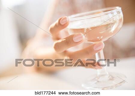 Picture - Hispanic woman drinking cocktail. Fotosearch