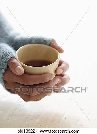 Stock Photo - Hispanic woman holding cup of tea. Fotosearch