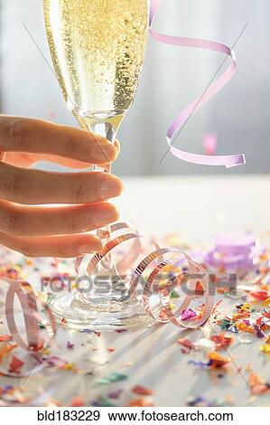 Stock Photo - Hispanic woman holding glass of champagne. Fotosearch