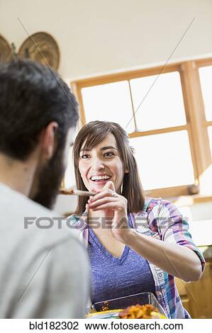 Hispanic woman serving boyfriend in kitchen View Large Photo Image Stock Image - Hispanic woman serving boyfriend in kitchen. Fotosearch
