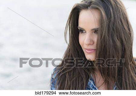 Picture - Hispanic woman smiling outdoors. Fotosearch