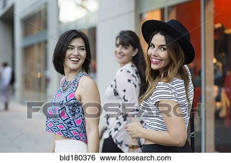 Stock Photograph - Hispanic woman smiling outdoors. Fotosearch