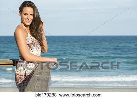 Hispanic woman standing on beach pier View Large Photo Image Stock Photo - Hispanic woman standing on beach pier. Fotosearch