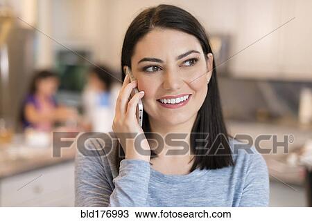 Hispanic woman talking on cell phone View Large Photo Image Stock Image - Hispanic woman talking on cell phone. Fotosearch