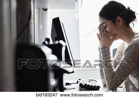Stock Photo - Hispanic woman using computer. Fotosearch