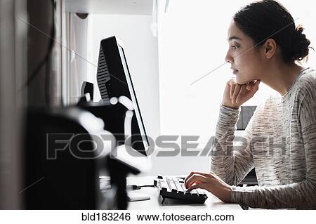 Hispanic woman using computer View Large Photo Image Stock Photograph - Hispanic woman using computer. Fotosearch