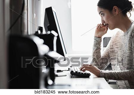 Hispanic woman using computer View Large Photo Image Stock Photography - Hispanic woman using computer. Fotosearch