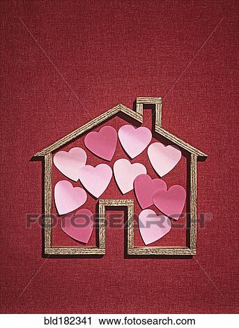 Stock Image - House shape with cutout hearts. Fotosearch